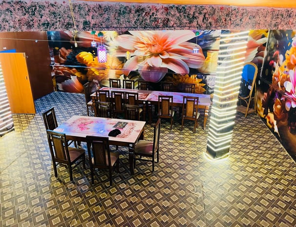 a restaurant with a large mural of flowers in Sarpanch Restaurant Bareilly Fatehganj