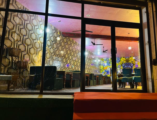 a restaurant with a large window and Sarpanch Restaurant Bareilly Fatehganj