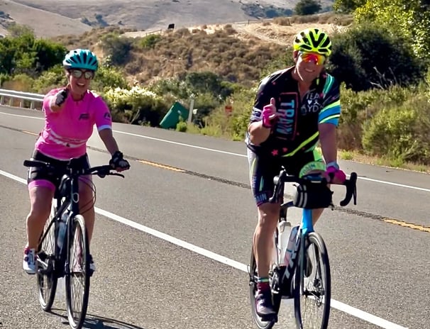 A man and a woman cycling in the outdoors