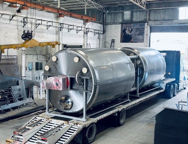 a train car being loaded with a tank