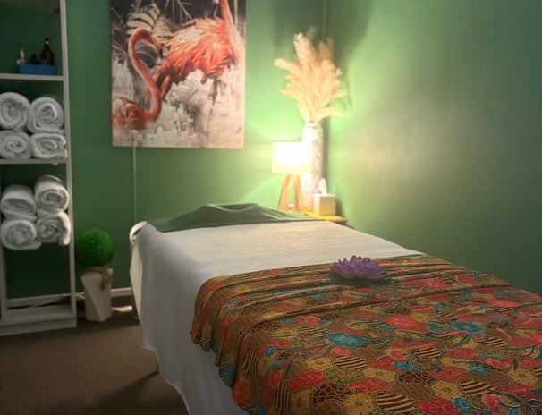 Tranquil Thai-style massage room at Ashburton Thai Massage & Spa with soft lighting, comfortable massage bed, and traditional