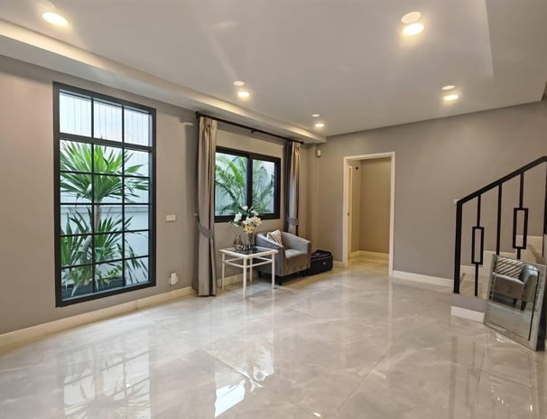 a living room with a couch and a staircase