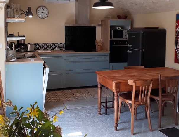 a kitchen with a table and chairs and a clock