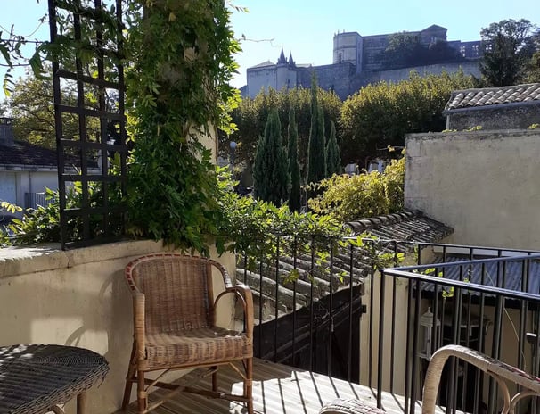 a balcony with a chair and a table