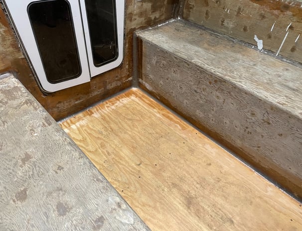 staring at the companionway door, the unfinished marine plywood cockpit with thickened epoxy fillets