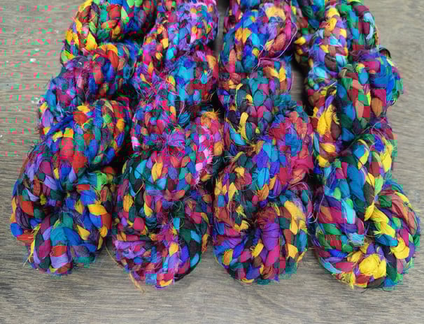Braided recycled sari silk ribbon yarn. 10-12 meters of ribbon in 100 gram skein