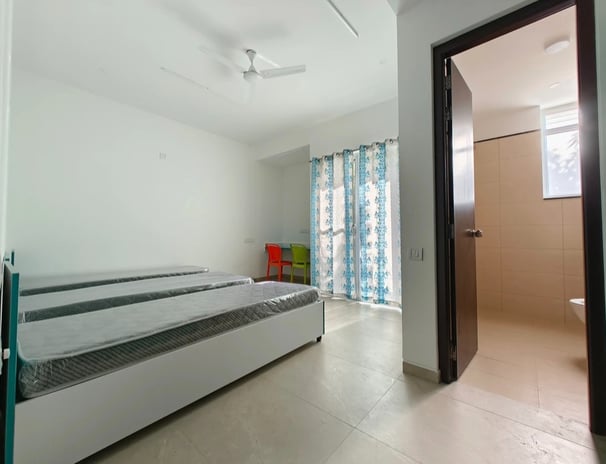 Spacious twin-sharing PG room in Banglore with a balcony, modern furniture, A/C and luxury.