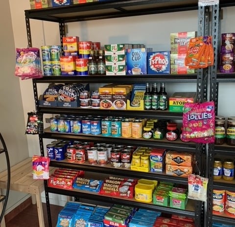 a shelf of food and snacks on a shelf