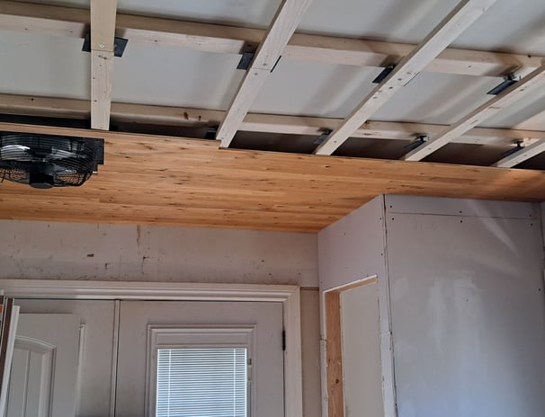 Wood ceiling framing installation in progress for residential levelling renovation project in Canada