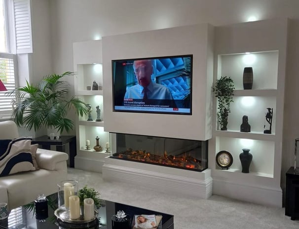 a living room with a television and a fireplace