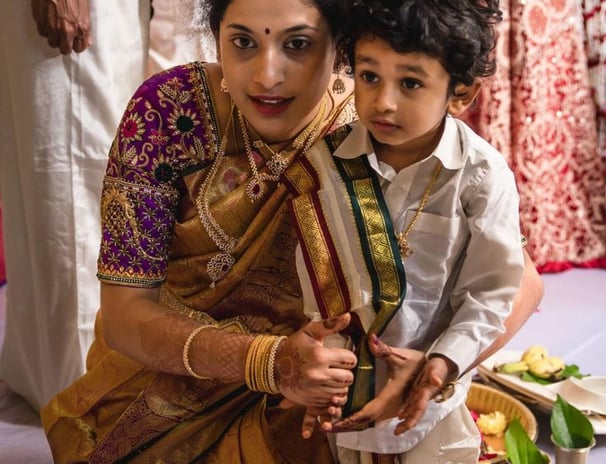 a woman and a young boy are sitting on a table