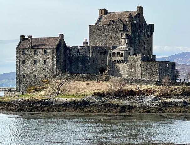 Castle in the day with water and countryside around
