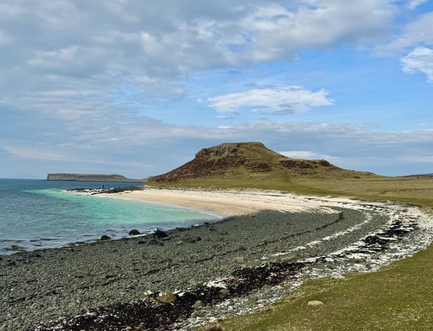 Black beach showing the clear sea