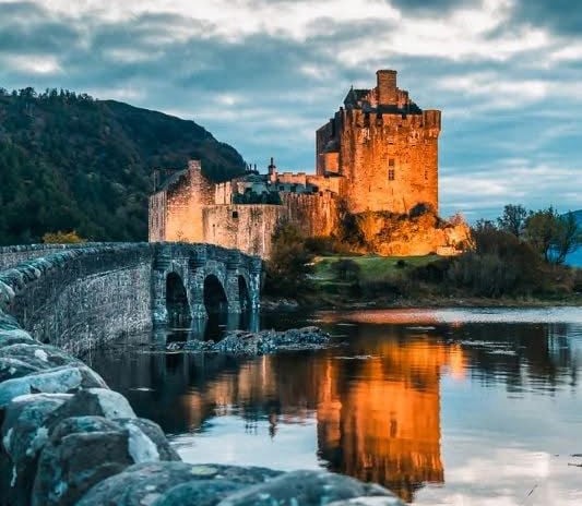 Castle at dusk with lights showing off the beautiful walls