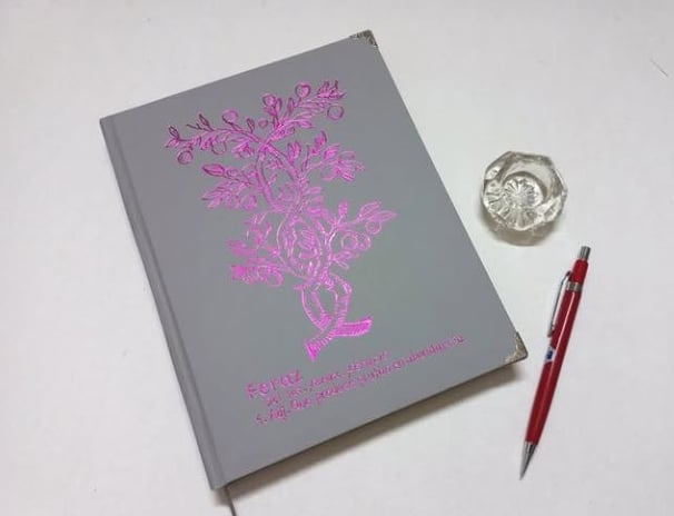 a book with a drawing of a hand holding a book