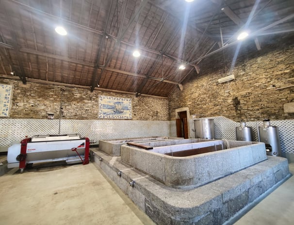 a stone wall with a stone bathtub and a stone wall