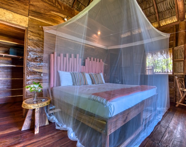 kingsize bed in wooden bungalow ecolodge