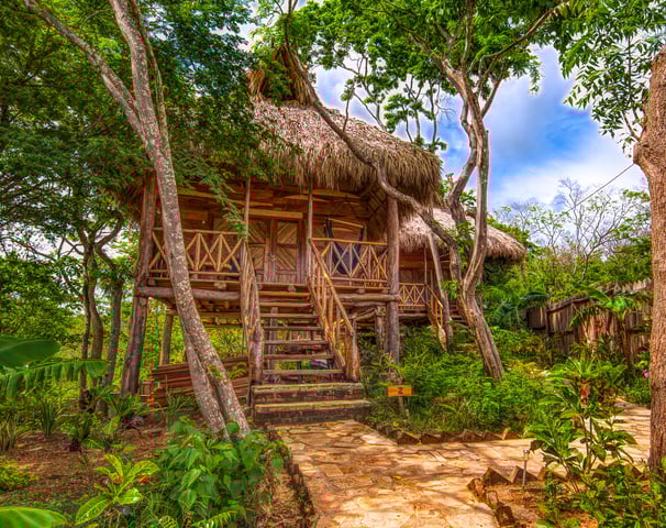 wooden bungalows in tropical garden retreat center