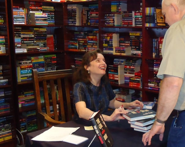 Kathryn Miller Haines autographs a hard back of The Girl is Murder at the release party.