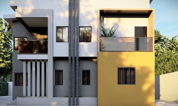 a yellow and white building with two balconies