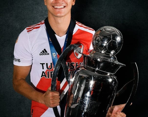 a man holding a trophy and a trophy