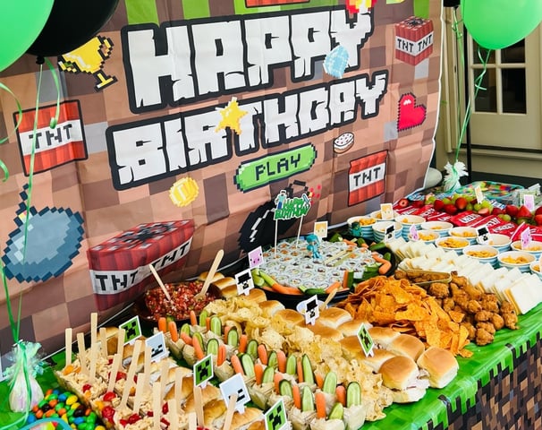 a table with a bunch of food and balloons