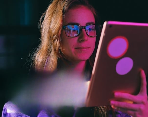 a woman in glasses and glasses is looking at a laptop