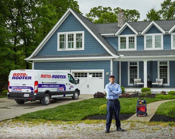 Roto-Rooter Service Technician Standing In Front of Residential Dwelling