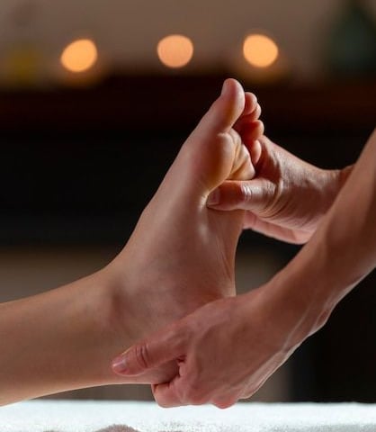 a person's foot and foot in a massage room