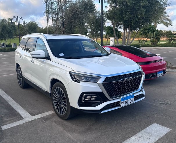 a white suv parked in a parking lot