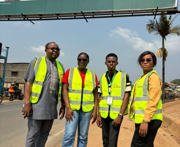 a group of people standing in front of a billboard