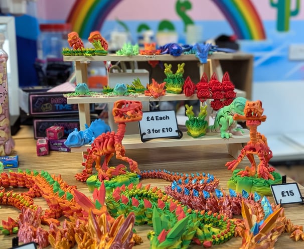 A table with a selection of different coloured 3d prints