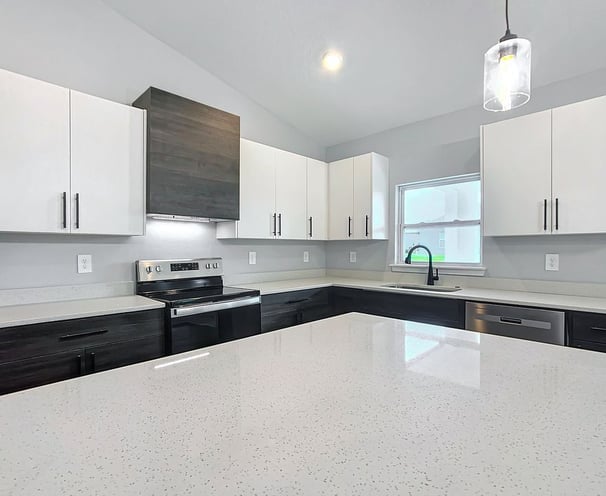 Modern kitchen renovation with quartz countertops, shaker cabinets, and recessed lighting installed