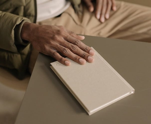 a person sitting at a table with a book