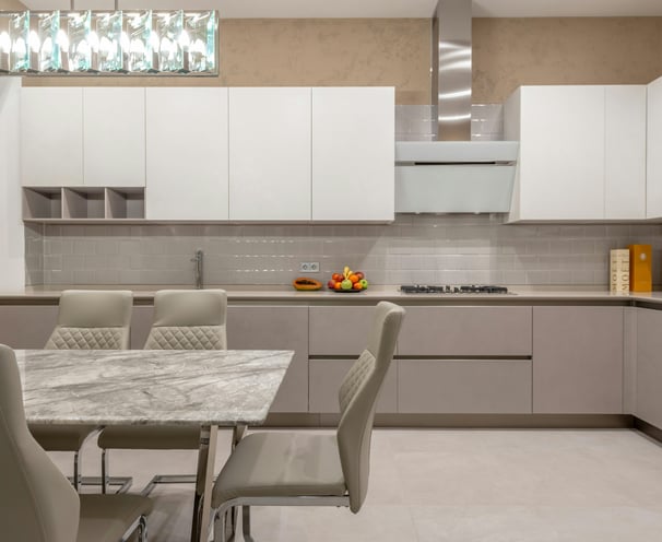 a kitchen with a marble table and chairs