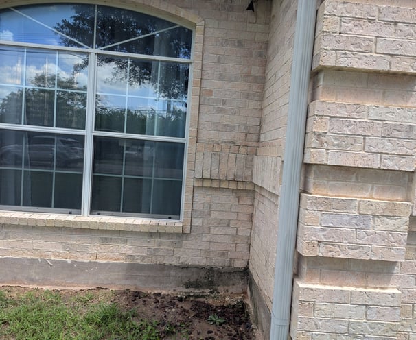 Hose Washing photo showing a window and brick after washing