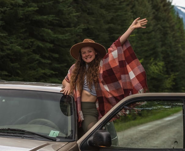 A band elopement photographer waving from a car