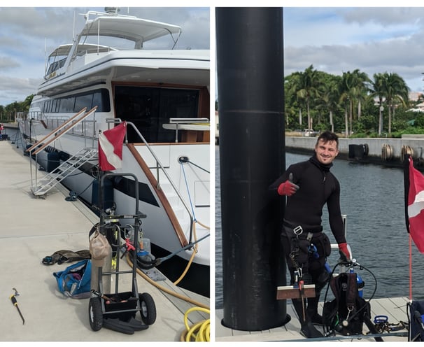 a man in a wetsuit standing next to a boat, boat bottom cleaning