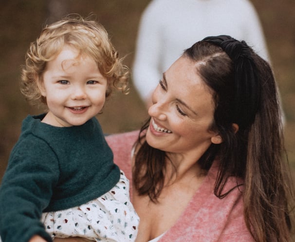 a woman holding a baby in her arms