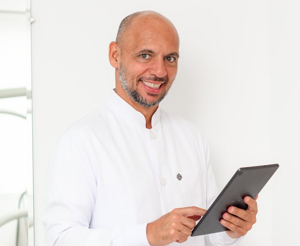 a man in a white shirt and a tablet computer