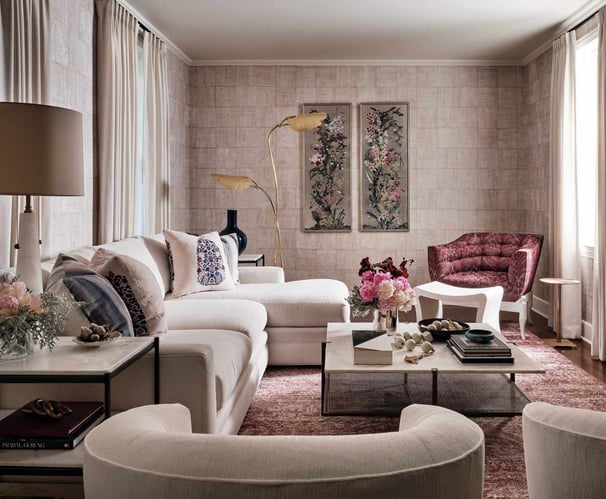 pink and tan wallpaper with neutral living room and mauve red rug