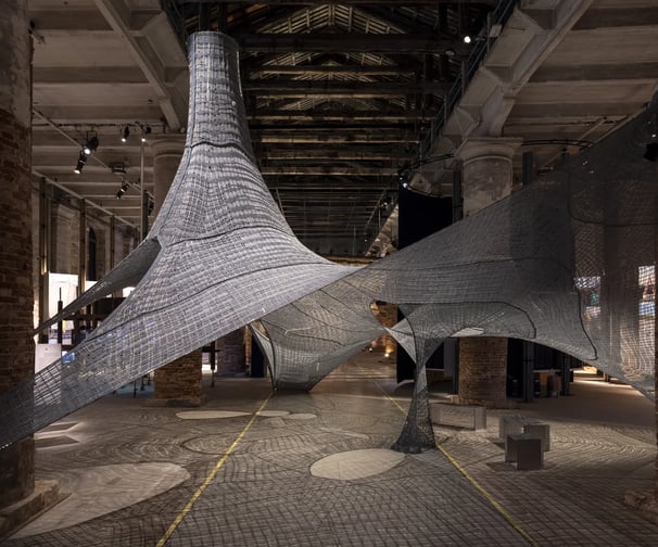 Modern architectural installation in an industrial-style exhibition space.
