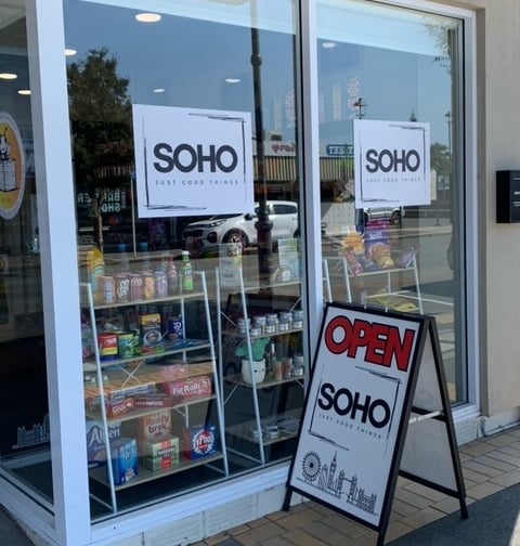 a sign boarder in front of a store