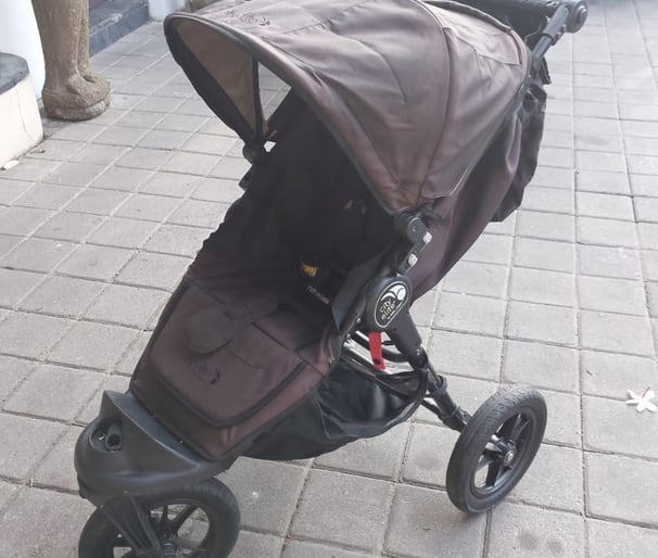 a stroller with a baby in a stroller