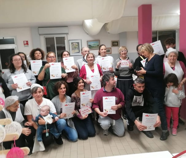 a group of people holding up certificates and holding up certificates