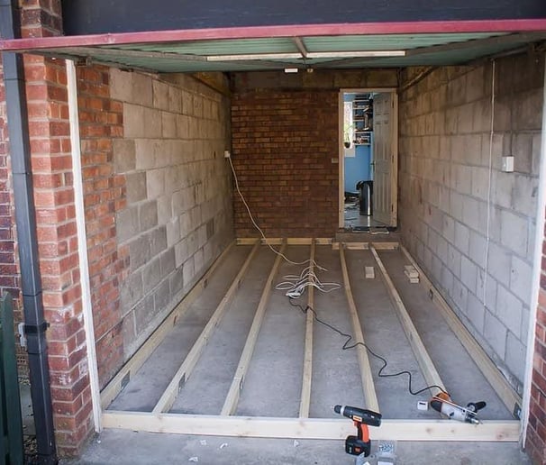 Brick garage conversions brighton & hove - flooring prep showing power tools and exposed brick