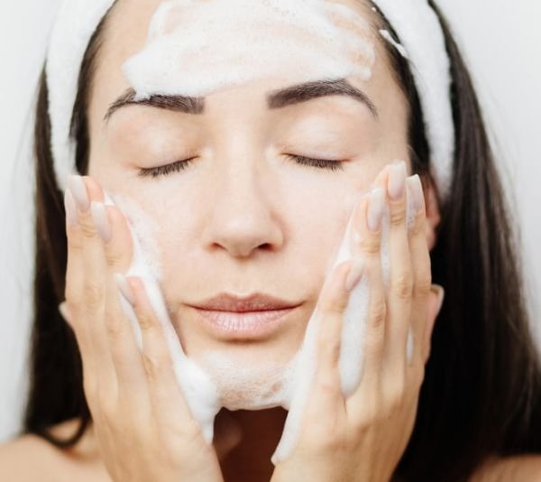 woman cleansing her skin