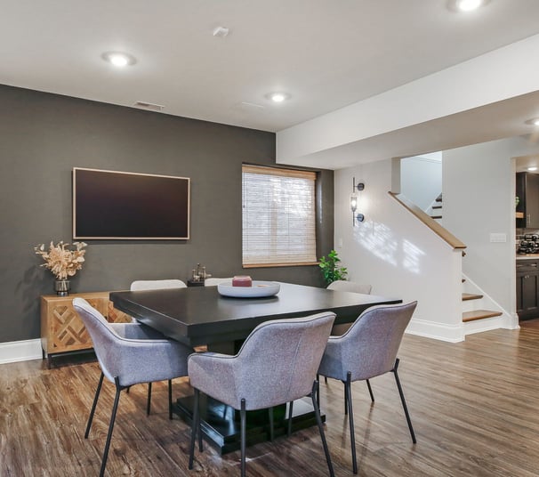 Open-concept finished basement in Cumming, Georgia with TV wall and kids’ play area