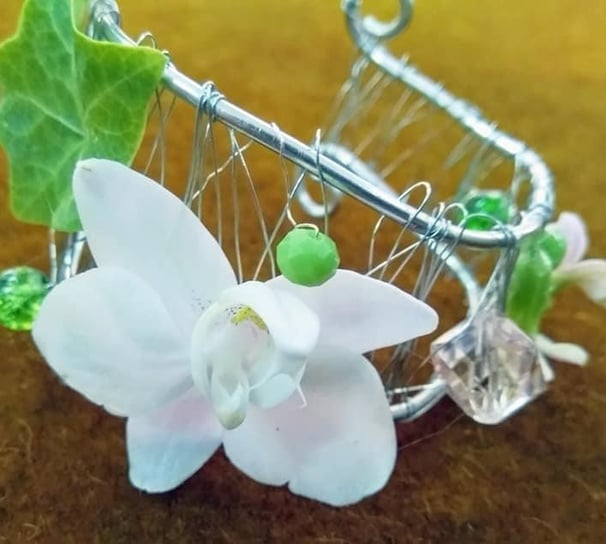 Brățară decorativă cu sârmă, orhidee albă, frunză de iederă și mărgele verzi.