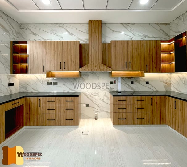 a kitchen with a marbled counter top and wooden cabinets